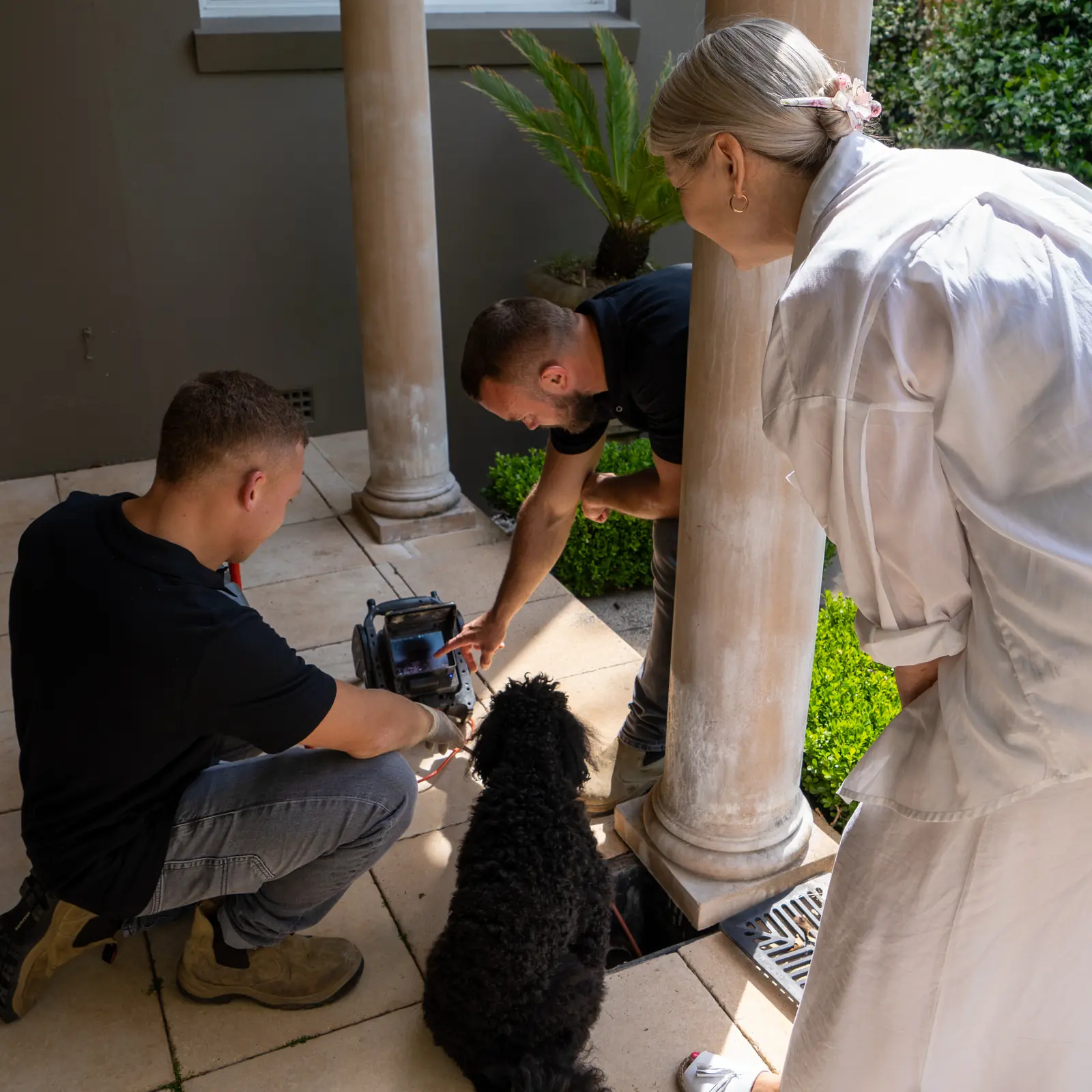 Johnny Drains specialist with a customer during a drain inspection